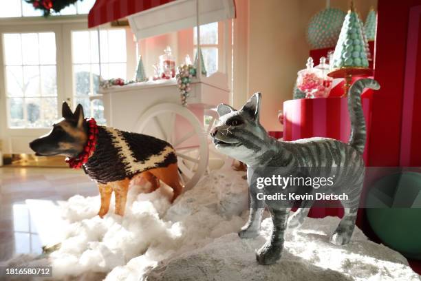 Decorated statues of the First Family's pets, Commander the dog and Willow the cat, are displayed in the East Wing during a media preview of the...