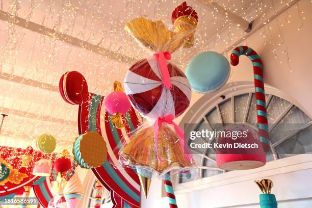 Candy-themed ornaments hang from the ceiling of the hallway between the East Wing and the Residence during a media preview of the holiday decorations...