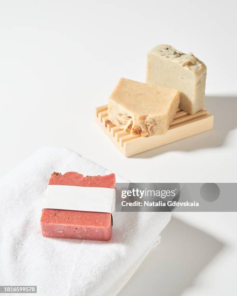 soap bar on towel and on wooden soap dish in hard sun light. homemade soap bars for wash hand and body. natural organic soap for bathroom, toilet. aromatic cosmetic for bathtub. clean skin. - hands on a hard body stock pictures, royalty-free photos & images