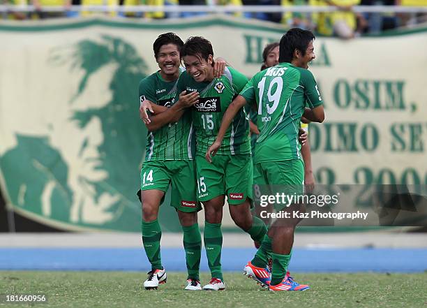 Junki Koike of Tokyo Verdy celebrates scoring his team's first goal with his team mates Jun Suzuki and Yusuke Mori during the J.League second...