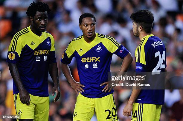 Wilfried Bony Jonathan De Guzman and Alejandro Pozuelo of Swansea City look on during the UEFA Europa League Group A match between Valencia CF and...