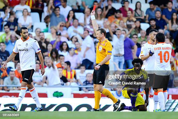 Referee Serge Gumienny shows a red card to Adil Rami of Valencia CF for a challenge on Wilfried Bony of Swansea City the UEFA Europa League Group A...