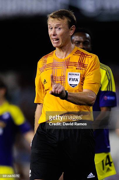 Referee Serge Gumienny argues with a Valencia CF player during the UEFA Europa League Group A match between Valencia CF and Swansea City at Estadi de...