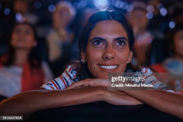 front view of young woman having a good time at the movies - indian couple in theaters stock pictures, royalty-free photos & images