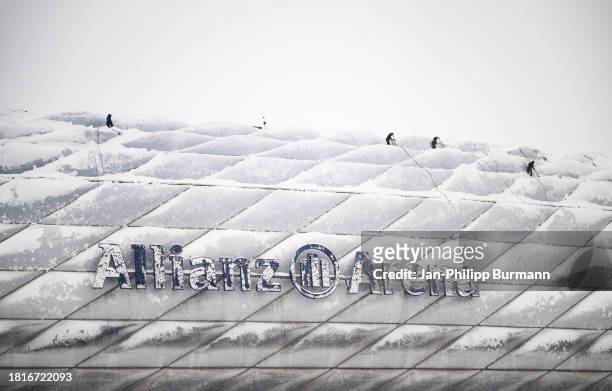 Roof of the Allianz Arena is freed from snow before the match between FC Bayern Munich and FC Union Berlin which was cancelled due to the weather...
