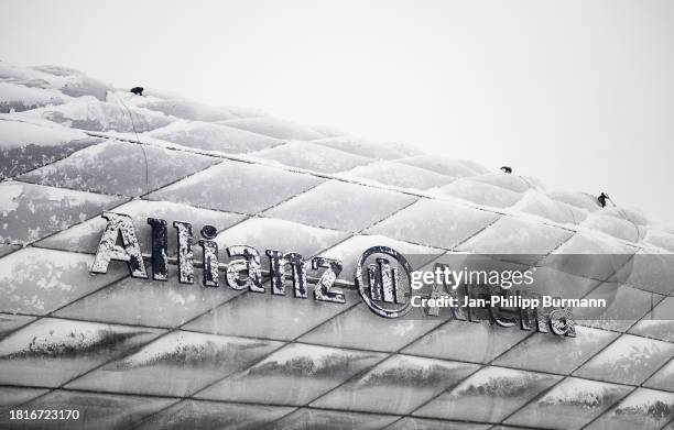 Roof of the Allianz Arena is freed from snow before the match between FC Bayern Munich and FC Union Berlin which was cancelled due to the weather...