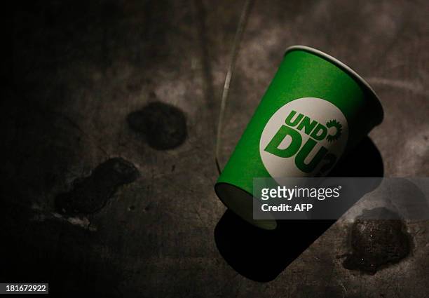 Paper cup with the election campaign logo of the German Green Party that reads "And you" , lies on the ground after a party leader's press conference...