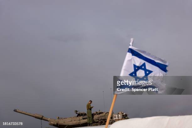 Members of the Israeli Defense Forces work at a staging area near the border of Gaza as a four day cease fire between Israel and members of Hamas...