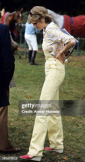 Lady Diana Spencer, wearing dungarees, attends a polo match at Windsor Great Park on July 12, 1981 in Windsor, England.