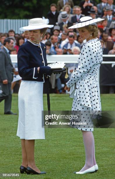 Diana Princess of Wales , wearing a dress by Victor Edelstein and hat by Frederick Fox and Princess Anne, Princess Royal attend the Epsom Derby on...