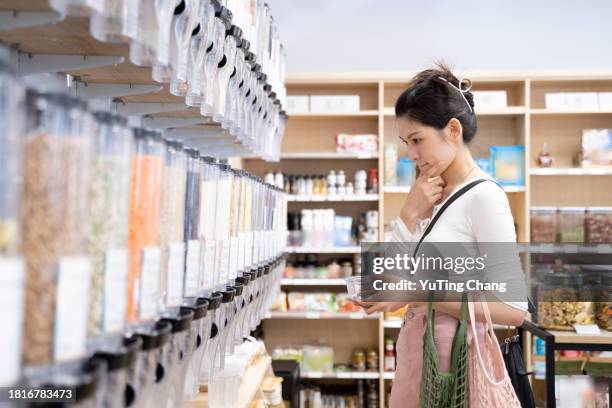 mindful shopping at unpackaged groceries store - yuting stock pictures, royalty-free photos & images