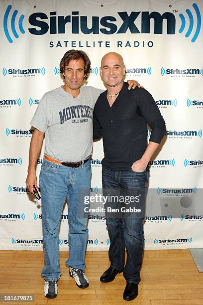 Mad Dog radio host Chris "Mad Dog" Russo and former professional tennis player Andre Agassi pose at SiriusXM Studios on September 23, 2013 in New...
