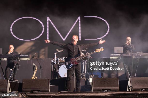 Singers Martin Cooper, Andy McCluskey and Paul Humphreys of Orchestral Manoeuvres in the Dark performs onstage during The Darker Waves Festival on...