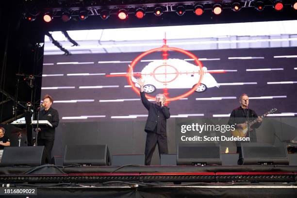 Singers Martin Cooper, Andy McCluskey and Paul Humphreys of Orchestral Manoeuvres in the Dark performs onstage during The Darker Waves Festival on...