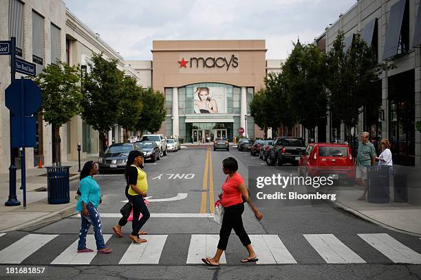 Shoppers cross the street in front of a Macy's Inc. Department store at Easton Town Center in Columbus, Ohio, U.S., on Friday, Sept. 20, 2013. The...