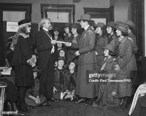 American heiress, artist and philanthropist Huguette Clark stands beside her father, American politician William A Clark as he presents the deed to...