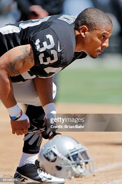 Safety Tyvon Branch of the Oakland Raiders stretches before a game against the Jacksonville Jaguars on September 15, 2013 at O.co Coliseum in...