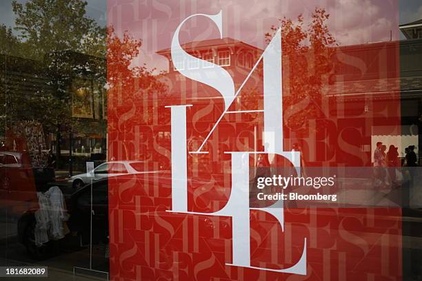 The reflections of shoppers are seen in the window of a Banana Republic LLC store window at Easton Town Center in Columbus, Ohio, U.S., on Friday,...