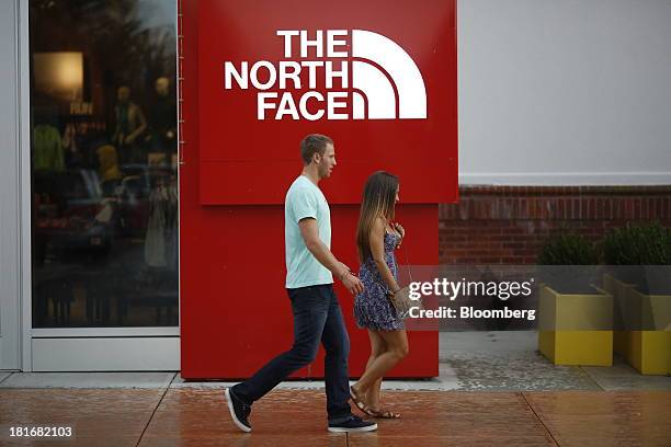 Shoppers walk past a North Face Inc. Store at Easton Town Center in Columbus, Ohio, U.S., on Friday, Sept. 20, 2013. The U.S. Conference Board is...