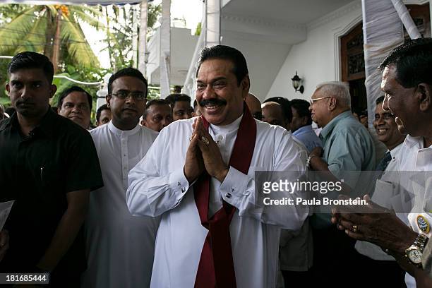 Sri Lankan President Mahinda Rajapaksa greets officials and friends as he works the crowd at the opening of the Sumanadasa Abeygunaward Astrological...