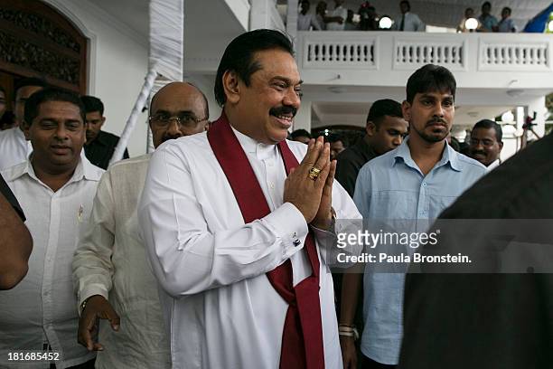 Sri Lankan President Mahinda Rajapaksa greets officials and friends as he works the crowd at the opening of the Sumanadasa Abeygunaward Astrological...
