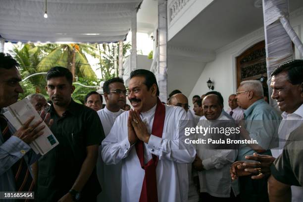 Sri Lankan President Mahinda Rajapaksa greets officials and friends as he works the crowd at the opening of the Sumanadasa Abeygunaward Astrological...