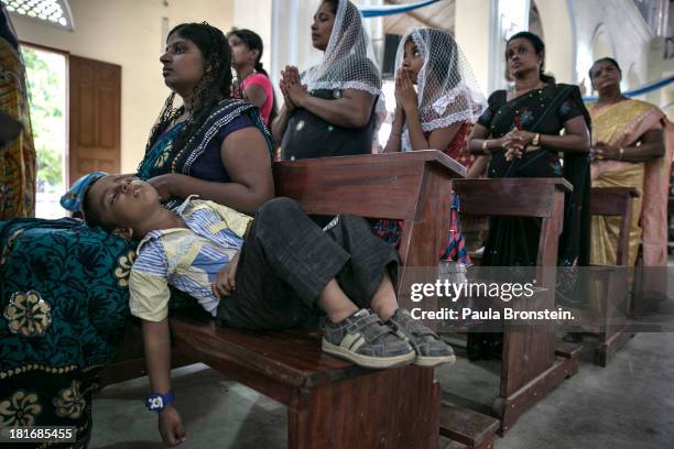 Tamils pray during mass at St. Mary's Cathedral, Jaffna, Sri Lanka, July 7, 2013. War's end has unleashed Sinhalese nationalism that has Tamils...