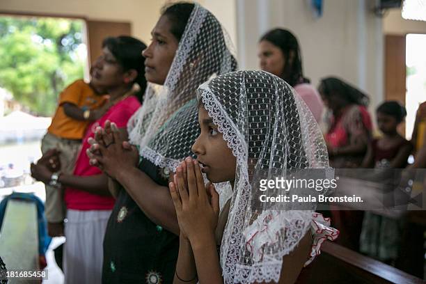Tamils pray during mass at St. Mary's Cathedral, Jaffna, Sri Lanka, July 7, 2013. War's end has unleashed Sinhalese nationalism that has Tamils...