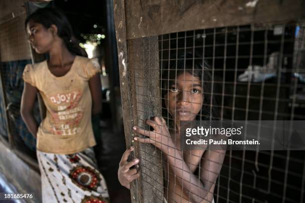 Displaced Tamils look out from their home living in temporary camps outside Jaffna, Sri Lanka, July 8, 2013. War's end has unleashed Sinhalese...