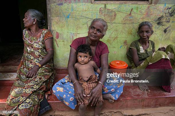 Komala holds her grand daughter Akshaya living in temporary camps for displaced Tamils outside Jaffna, Sri Lanka, July 8, 2013. War's end has...