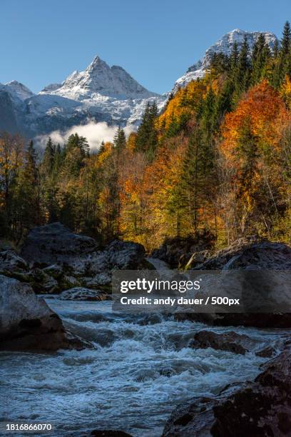 scenic view of river by mountains against sky during autumn - andy dauer stockfoto's en -beelden