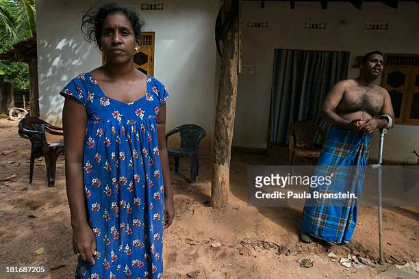 Tamil War Victim Ravi Chandran ¨ and his wife Pusparani, stand outside their house in Mullaitivu, Sri Lanka, July 8, 2013. War's end has unleashed...