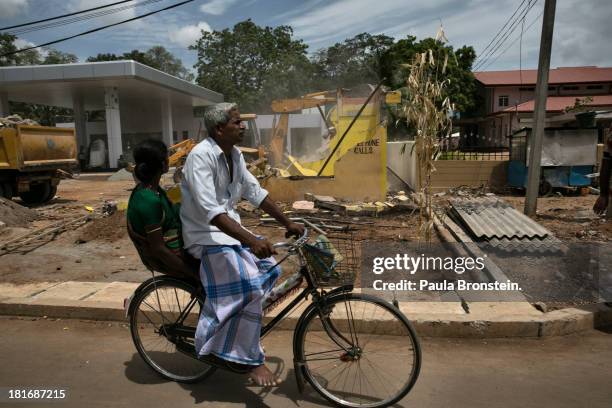 People ride by as rebuilding continues outside of Jaffna, Sri Lanka, July 9, 2013. War's end has unleashed Sinhalese nationalism that has Tamils...