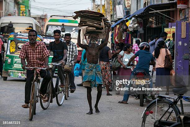 People and traffic move along in downtown Jaffna, Sri Lanka, July 9, 2013. War's end has unleashed Sinhalese nationalism that has Tamils fearful of...