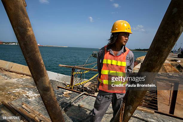 Chinese workers are seen building the Mahida Rajapaksa Port in Hambantota, July 6, 2013. War's end has unleashed Sinhalese nationalism that has...
