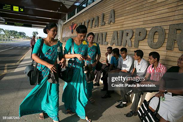 Airline employees walk by the main terminal of the new Mattala Rajapaksa International airport in Hambantota, July 6, 2013. War's end has unleashed...