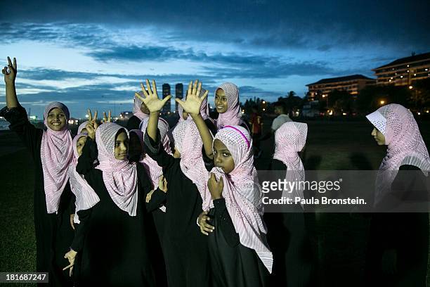 Muslim students from an Islamic school enjoy the ocean breeze at a city park in Colombo,Sri Lanka, July 10, 2013. War's end has unleashed Sinhalese...