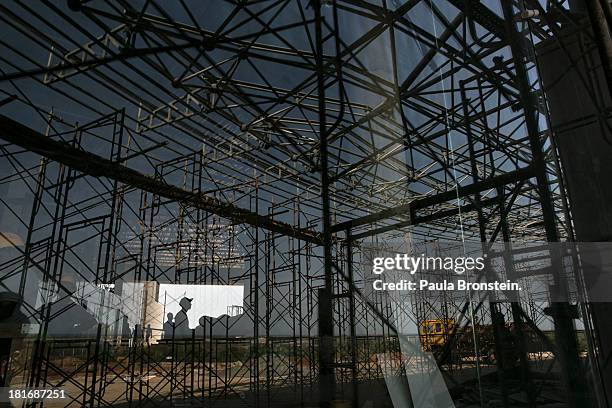 Sri Lankan construction workers build a new convention center after years of falling behind schedule in Hambantota, July 6, 2013. War's end has...