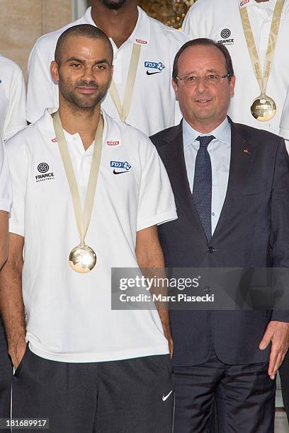 French basketball player Tony Parker poses with French President Francois Hollande at the Elysee presidential palace on September 23, 2013 in Paris,...