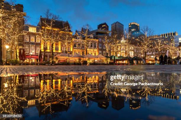 reflections of light decorations in the city - christmas town stock pictures, royalty-free photos & images