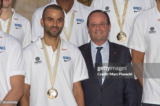 French basketball player Tony Parker poses with French President Francois Hollande at the Elysee presidential palace on September 23, 2013 in Paris,...