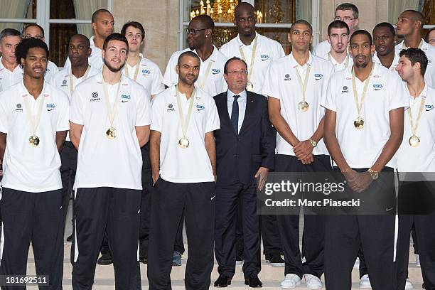 French basketball player Tony Parker poses with French President Francois Hollande at the Elysee presidential palace on September 23, 2013 in Paris,...