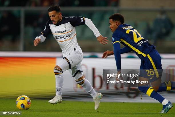 Nicola Sansone of Lecce gets away from Cyril Ngonge of Verona during the Serie A TIM match between Hellas Verona FC and US Lecce at Stadio...