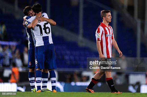 Iker Muniain of Athletic Club leaves the pitch dejected after being defeated as Victor Sanchez of RCD Espanyol and his team-mate Javi Lopez of RCD...