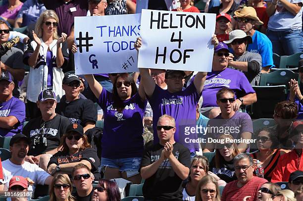 Fans display signs in support of Todd Helton of the Colorado Rockies against the St. Louis Cardinals at Coors Field on September 19, 2013 in Denver,...