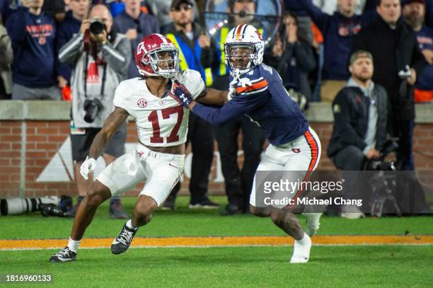 Wide receiver Isaiah Bond of the Alabama Crimson Tide looks to catch a pass in front of cornerback D.J. James of the Auburn Tigers during the second...