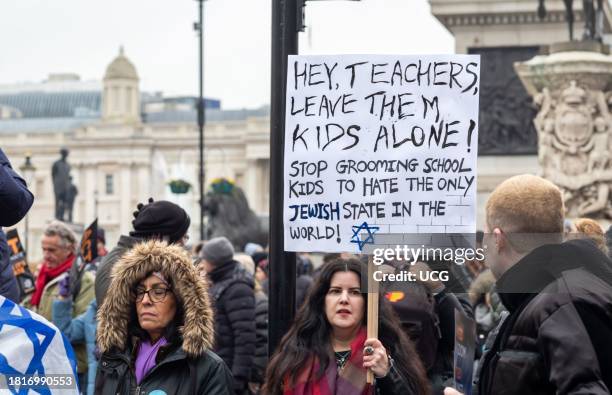 London, UK, November 26 2023, A pro-Israeli protester at the "March Against Antisemitism" holds a placard in Trafalgar Square.