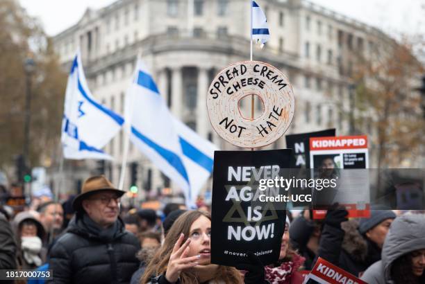 London, UK, November 26 2023, Pro-Israeli protesters at the "March Against Antisemitism" hold flags and placards in support of hostages taken by...