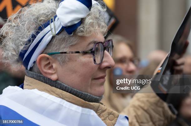 London, UK, November 26 2023, A female pro-Israeli protester wrapped in an Israeli flag at the "March Against Antisemitism" protests in support of...