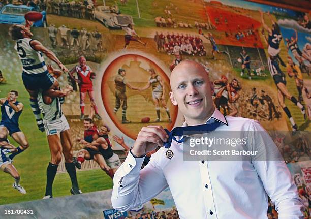 Gary Ablett Jnr of the Gold Coast Suns poses with the Brownlow medal at AFL House on September 24, 2013 in Melbourne, Australia. Ablett won the 2013...